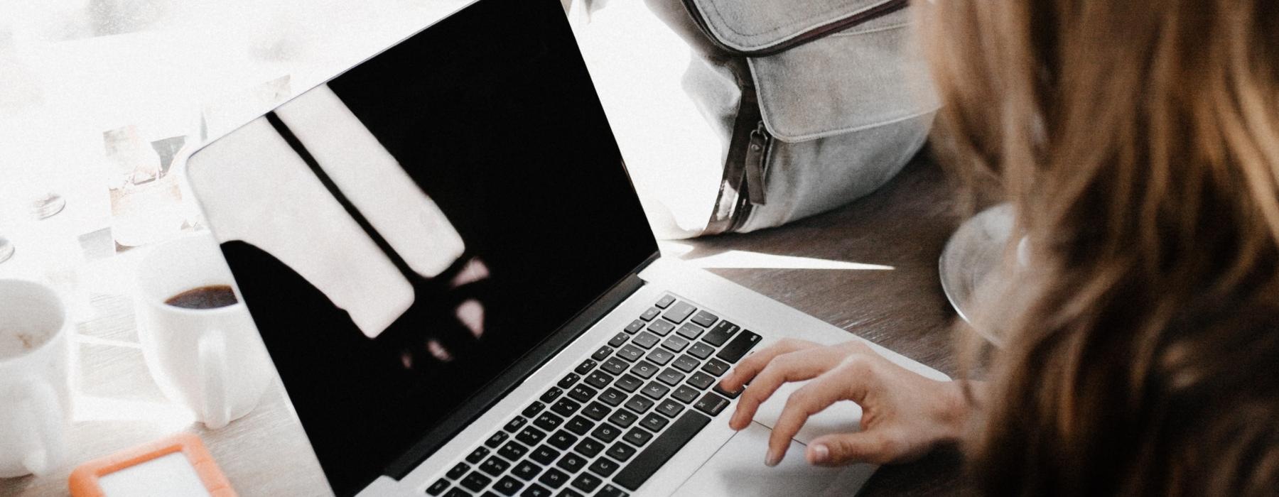 woman on a laptop in front of a window