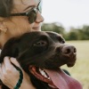 woman holding a dog in a park